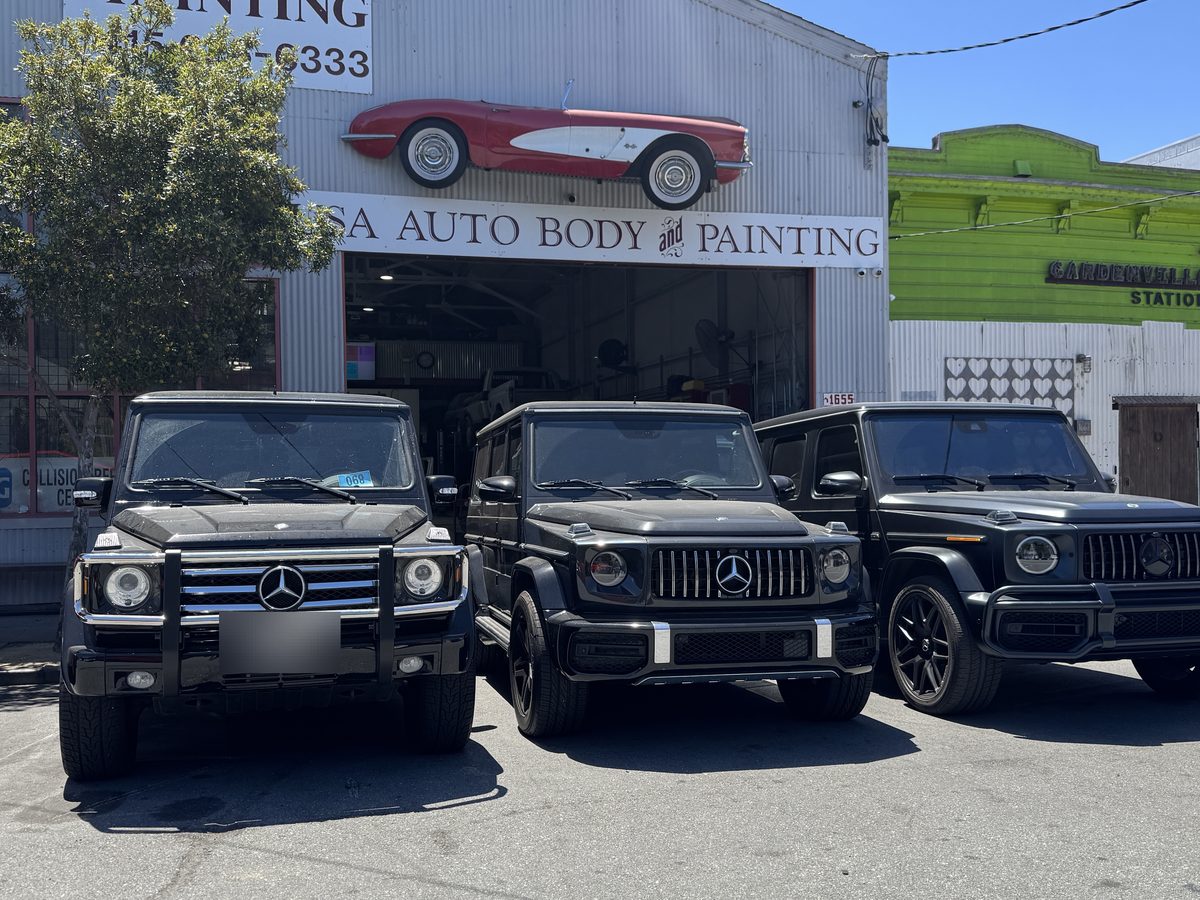 The USA Autobody and Painting shop front on Jerrold Avenue, with the painted Corvette sign above the roller door